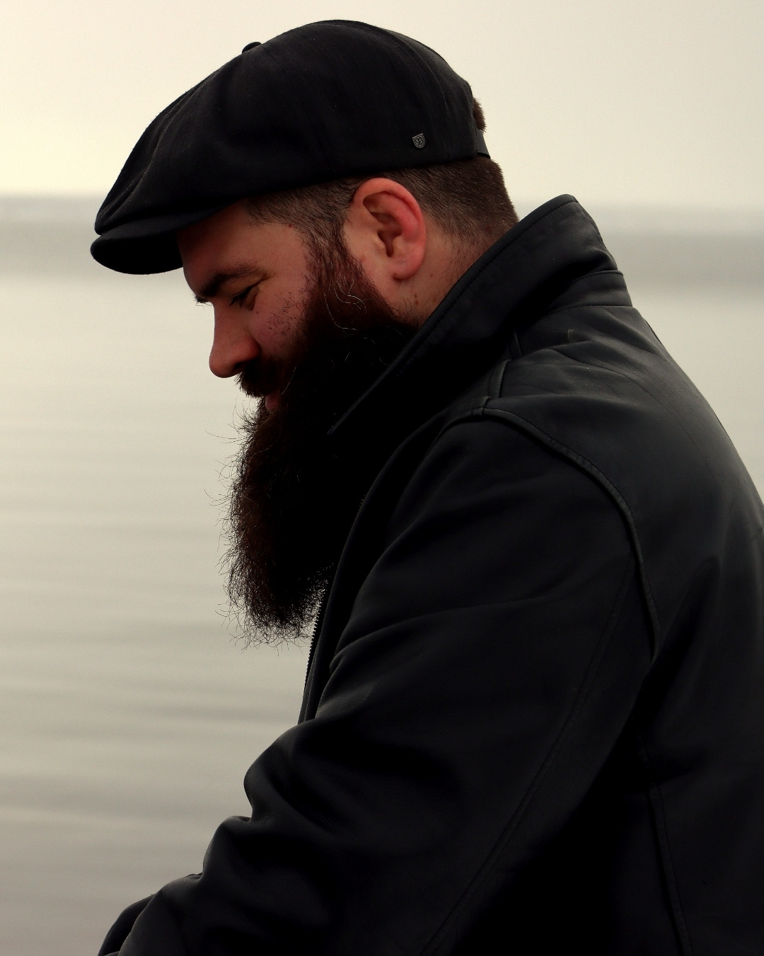 Caleb Taylor in a flat cap by the water